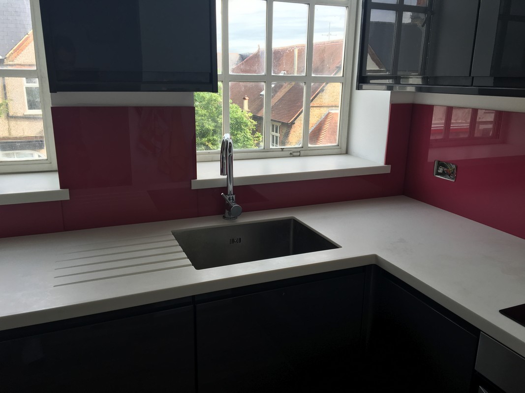 Deep plum coloured glass splashback in modern St Albans kitchen
